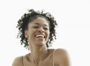 Gaithersburg, MD, USA --- Smiling African American woman --- Image by © Jon Feingersh/Blend Images/Corbis